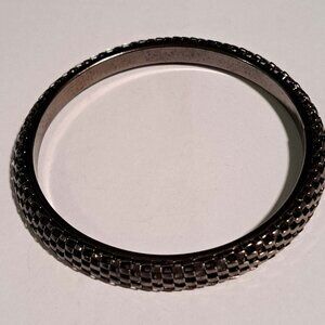 gun metal black color metal bracelet with cut out design on top and solid inside